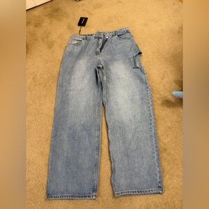 PrettyLittleThing Light Blue Wash Baggy Low Rise Asymmetric Waistband Jeans